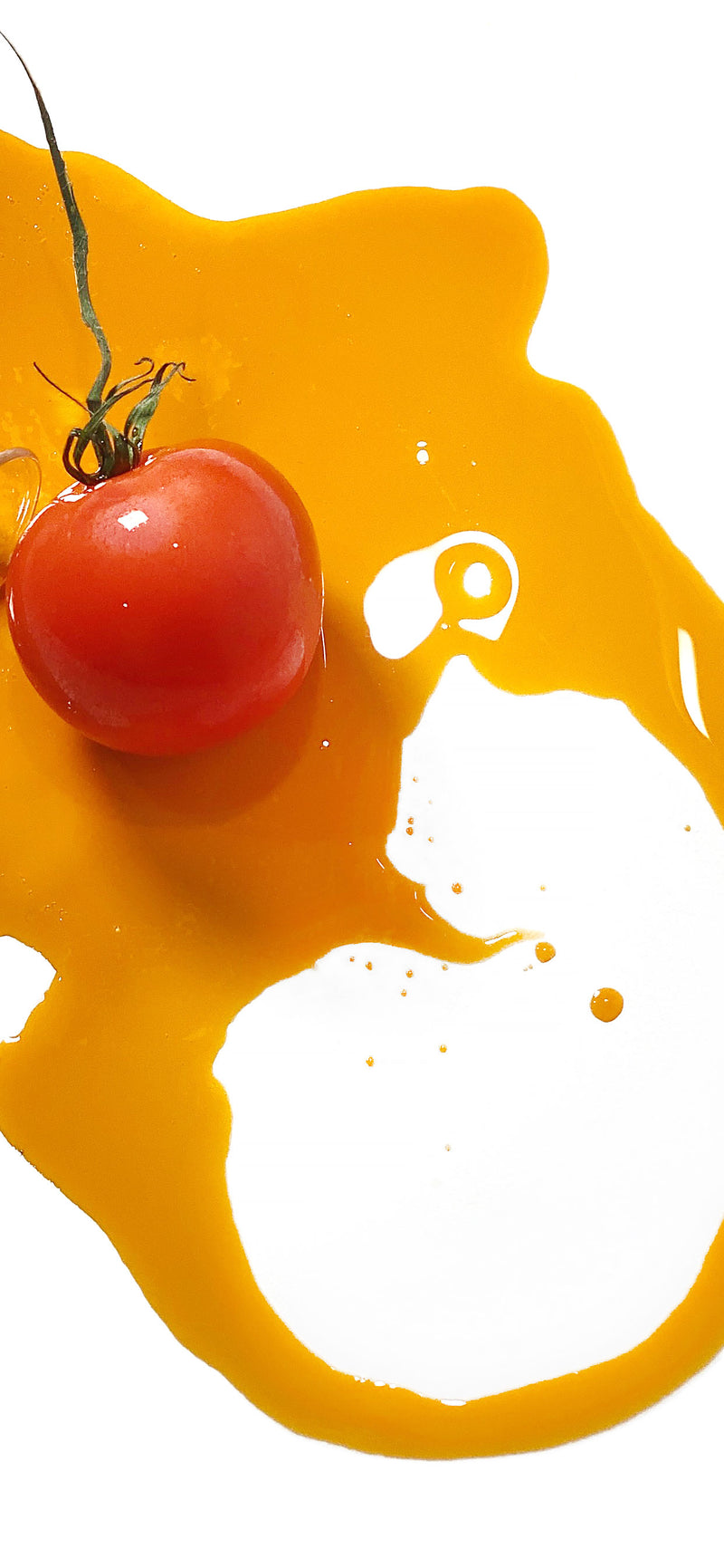 A tomato sitting in Red Velvet Oil (Tomato Seed Oil).