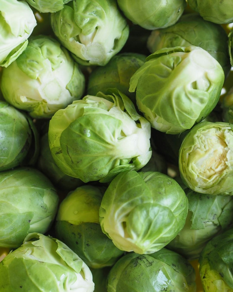 Small firm bright green little cabbages called Brussels sprouts