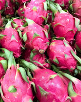 Whole bright pink dragfruits, scientifically known as Hylocereus undatus